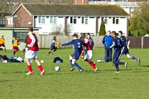 PLAYING SOCCER IN FIELD