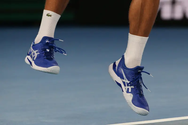 Grand Slam champion Novak Djokovic of Serbia wears custom Asis tennis shoes during his final match at the 2019 Australian Open.