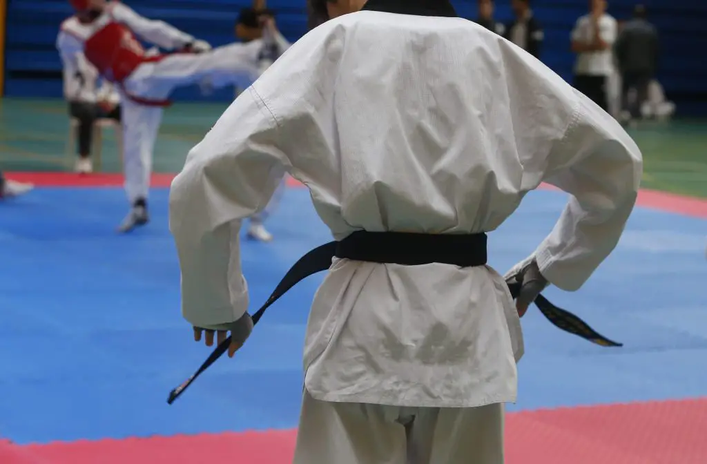 Conquer Your Taekwondo Black Belt Test Overcoming Nervousness And   Taekwondo Fighter Adjusting His Belt Before Competition Match Detail 1024x672 